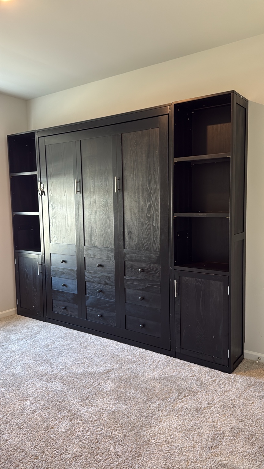 Large dark wood storage unit with doors, drawers and side shelves.