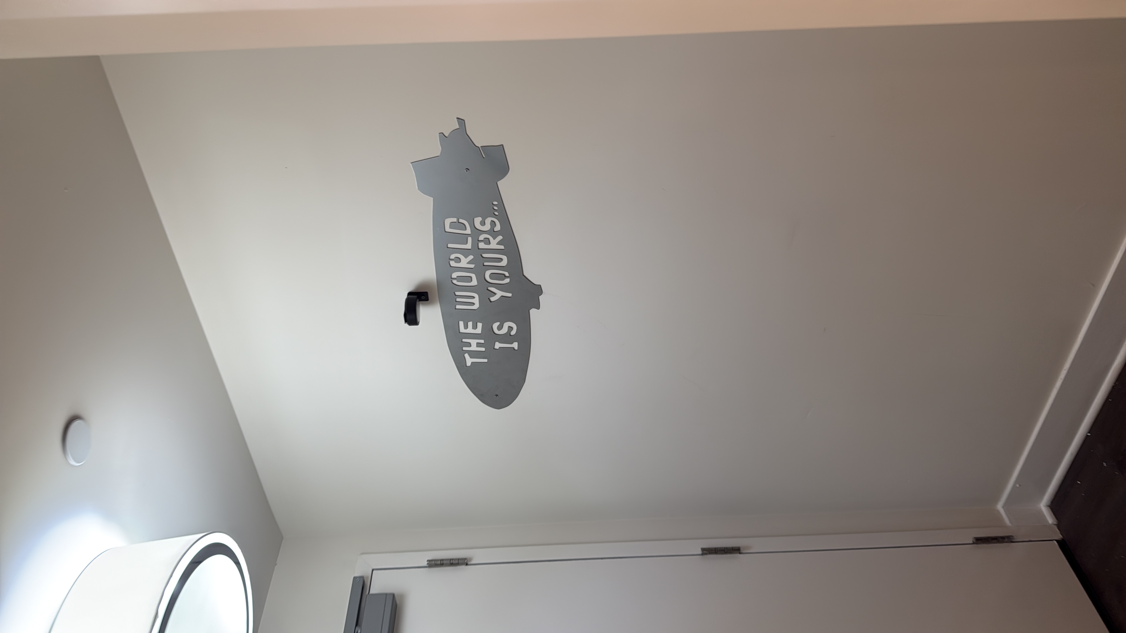 Airship-shaped wall decoration with an accent light above.